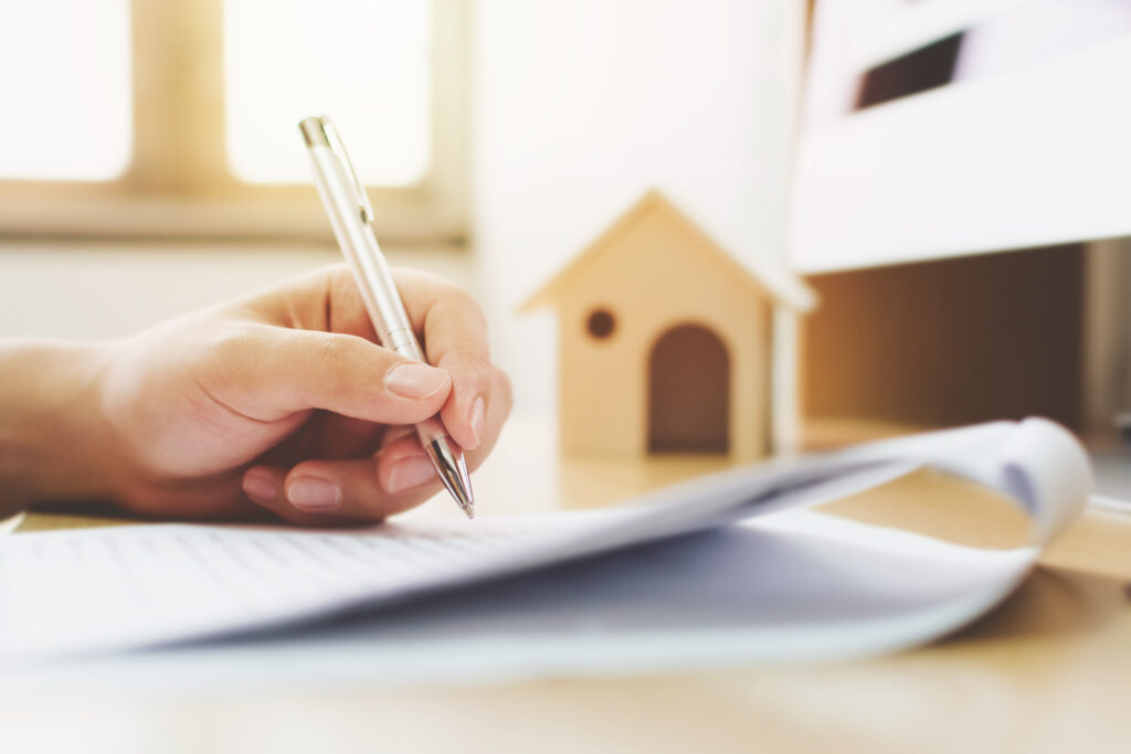 image of someone writing on paper with a pen about unregistered property